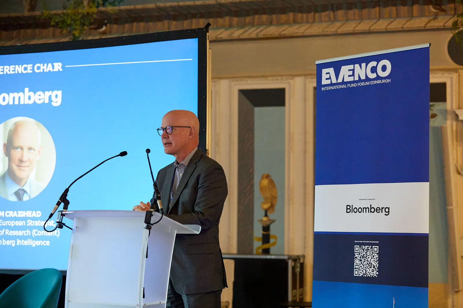 Conference chair at the lectern at an international fund forum in Edinburgh