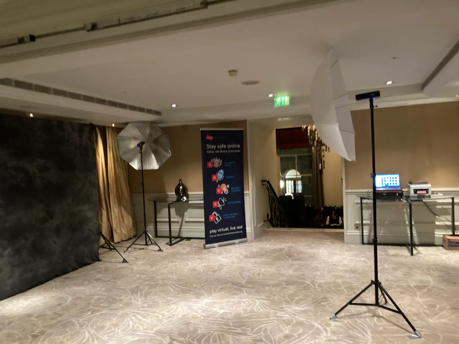 Pop-up studio with backdrop, lighting and print station in a hotel ballroom